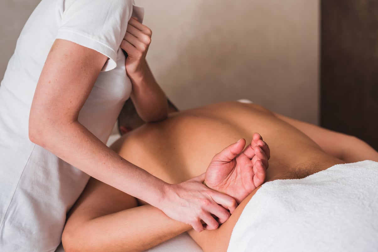 Man enjoying sports massage at spa